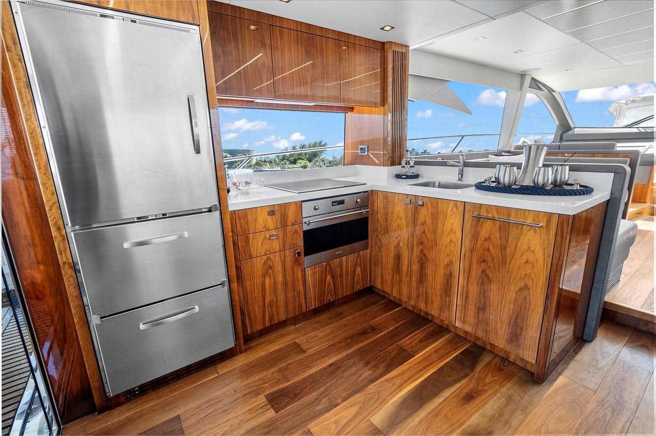 a kitchen with wooden cabinets aboard EXIT Yacht for Sale