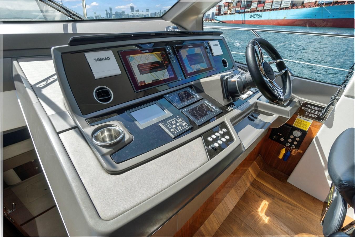 a car with a screen and a steering wheel aboard EXIT Yacht for Sale