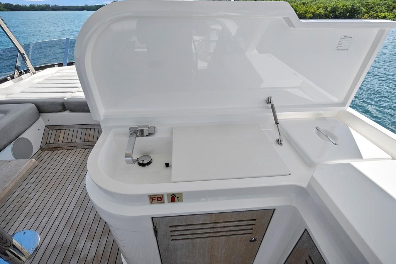 a white boat on a dock aboard EXIT Yacht for Sale