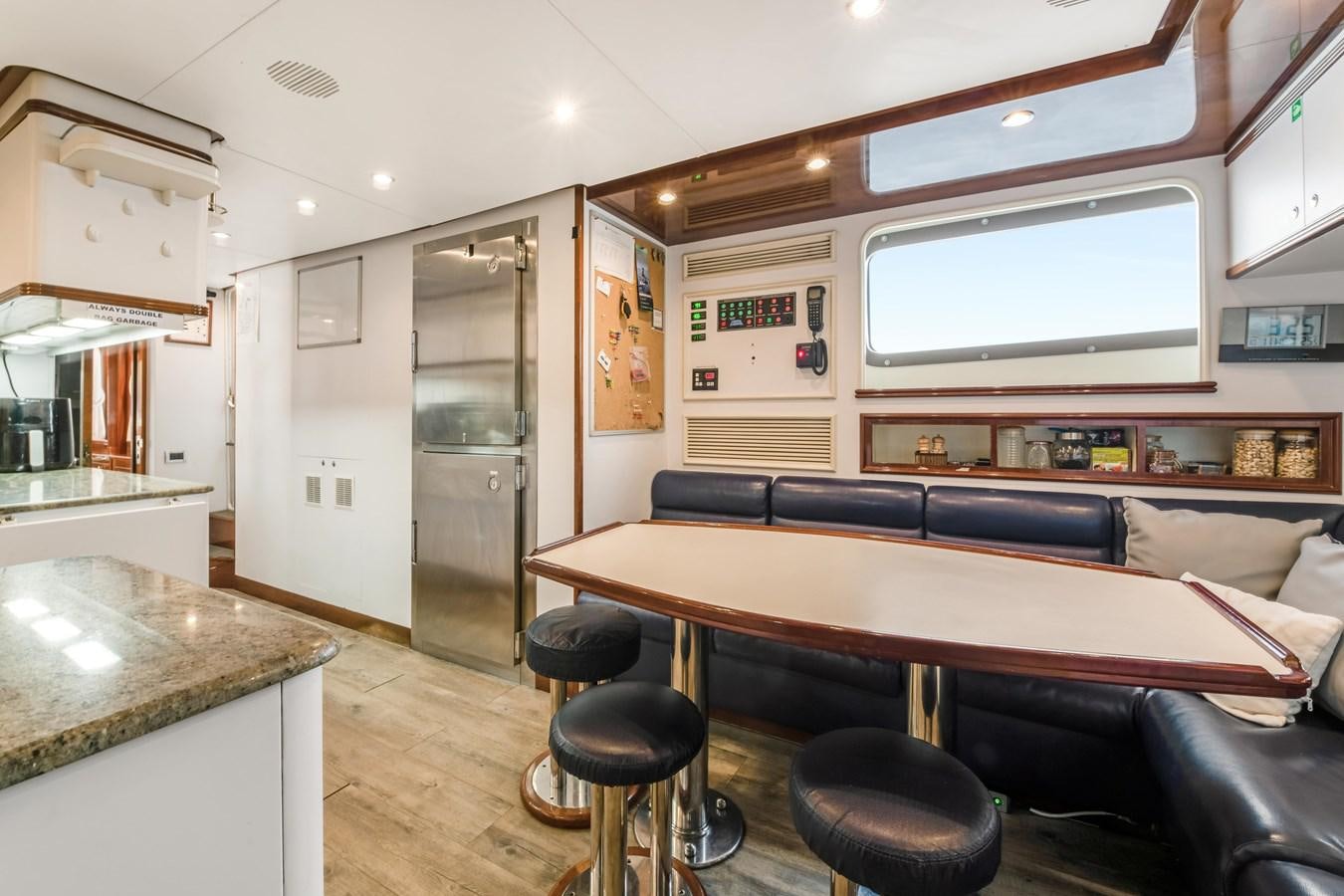 a room with a table and chairs aboard LOULOU Yacht for Sale
