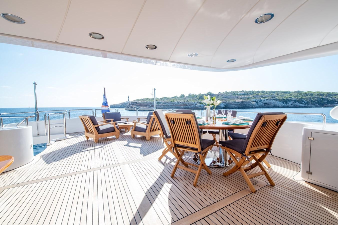 a large open area with a table and chairs on it aboard LOULOU Yacht for Sale