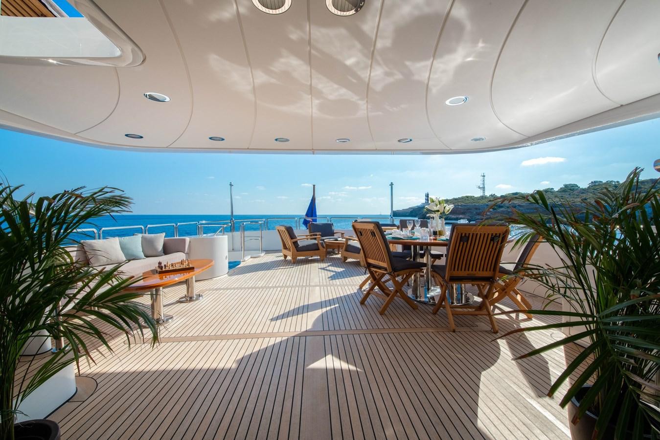 a room with a table chairs and plants aboard LOULOU Yacht for Sale