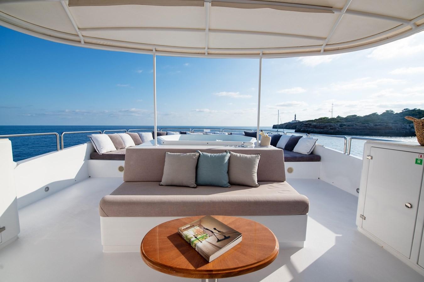 a living room with a couch and a table aboard LOULOU Yacht for Sale