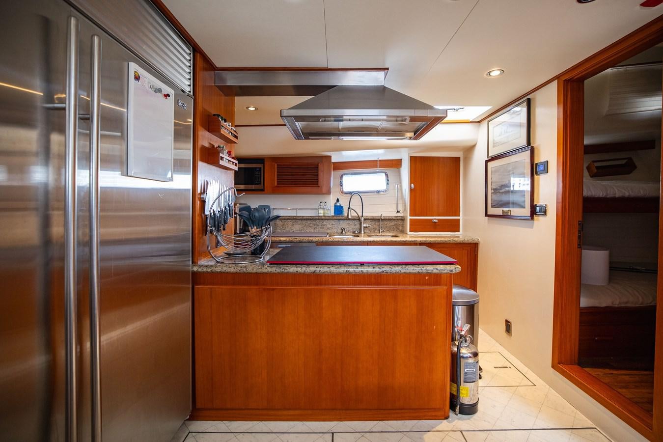 a kitchen with a stainless steel refrigerator aboard SEA BOLD Yacht for Sale