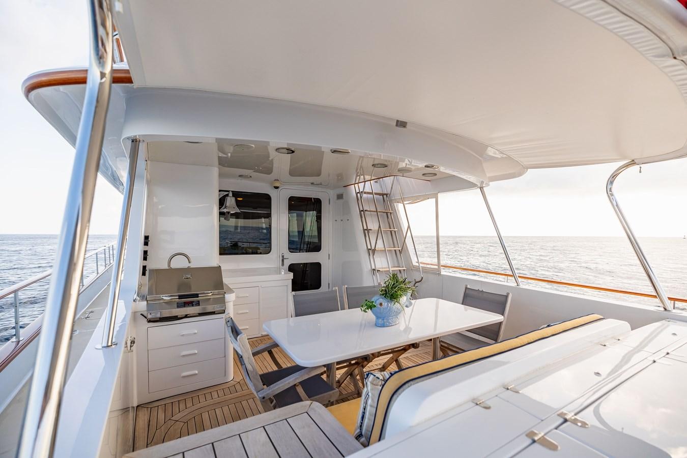 a large open space with a table and chairs aboard SEA BOLD Yacht for Sale
