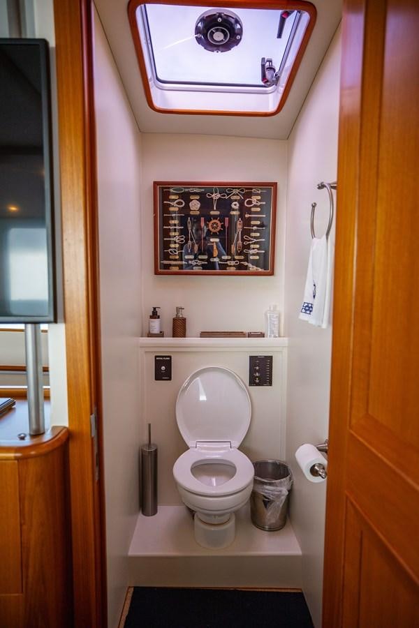a toilet with a picture on the wall aboard SEA BOLD Yacht for Sale