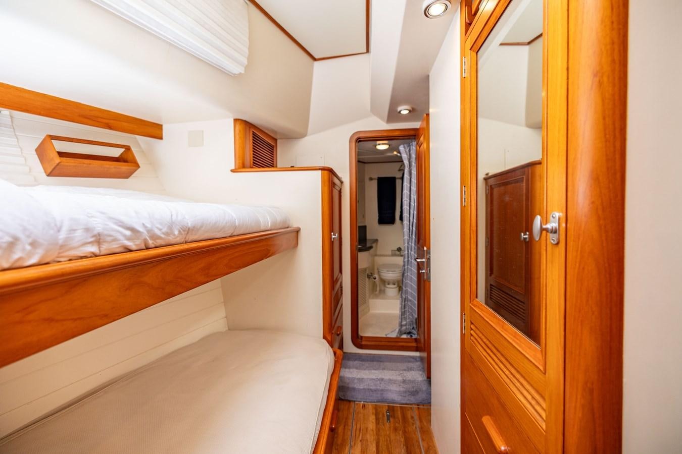 a bedroom with a bed and a mirror aboard SEA BOLD Yacht for Sale