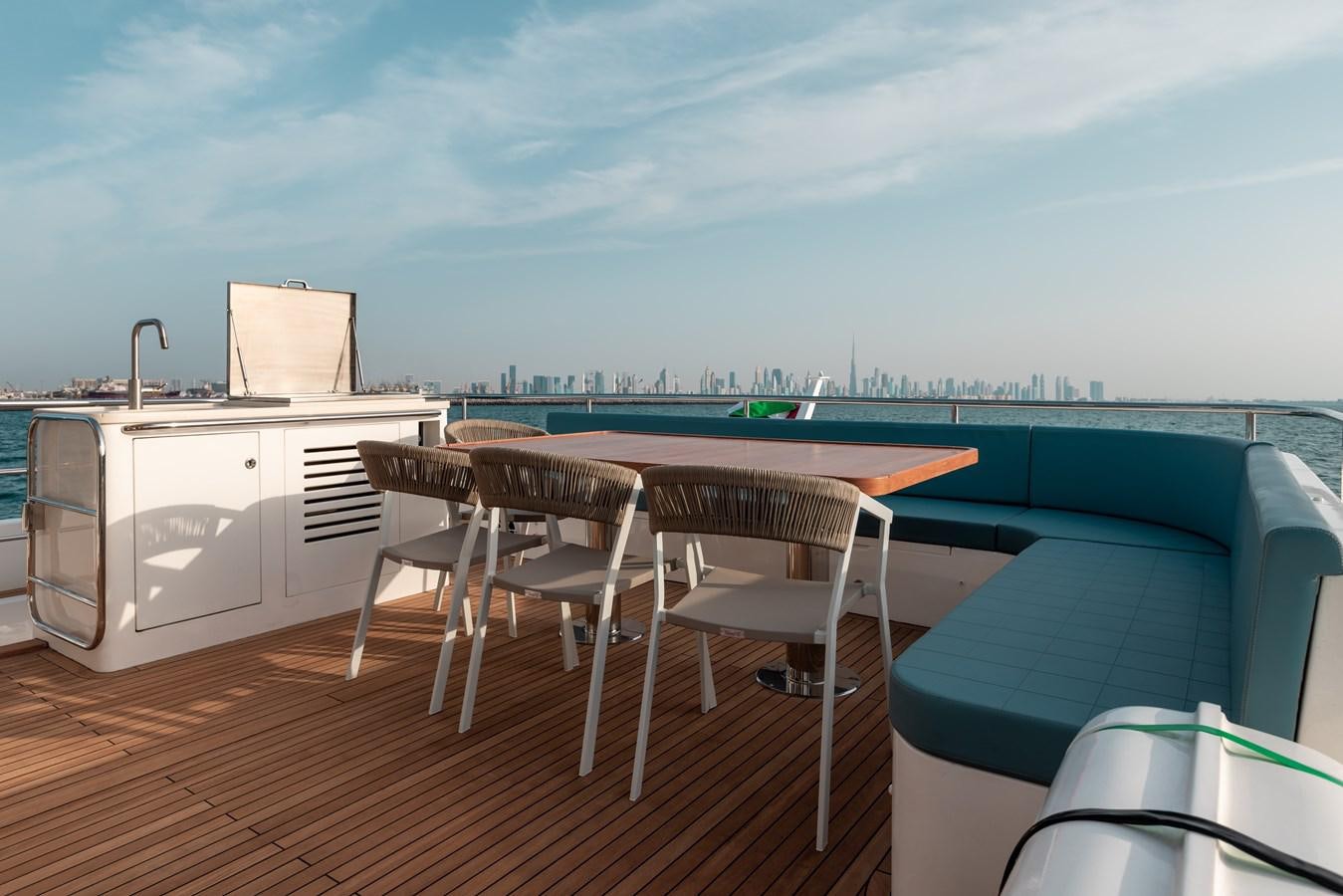a deck with a table and chairs on it aboard RODINIA 2 Yacht for Sale