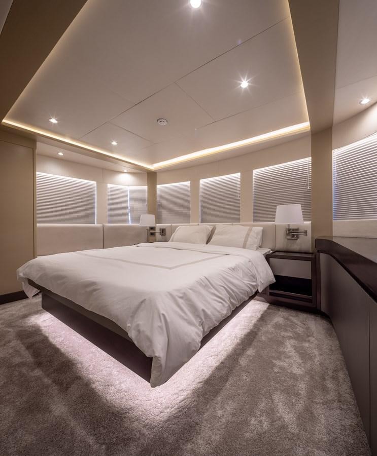 a bedroom with a bed and a lamp aboard RODINIA 2 Yacht for Sale