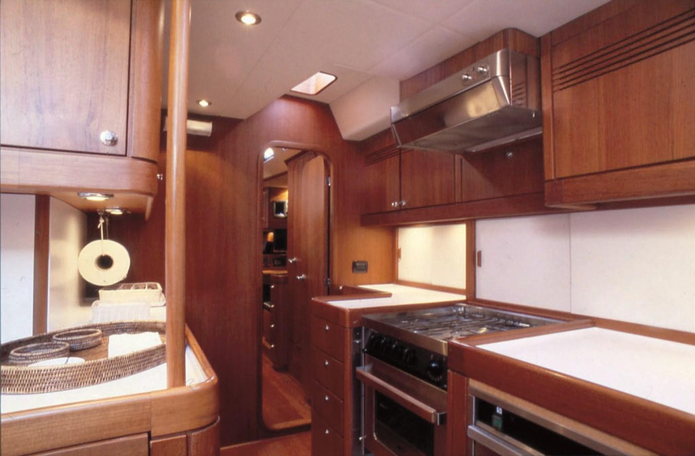 a kitchen with wooden cabinets aboard NAUTA-PETERSON 75 Yacht for Sale