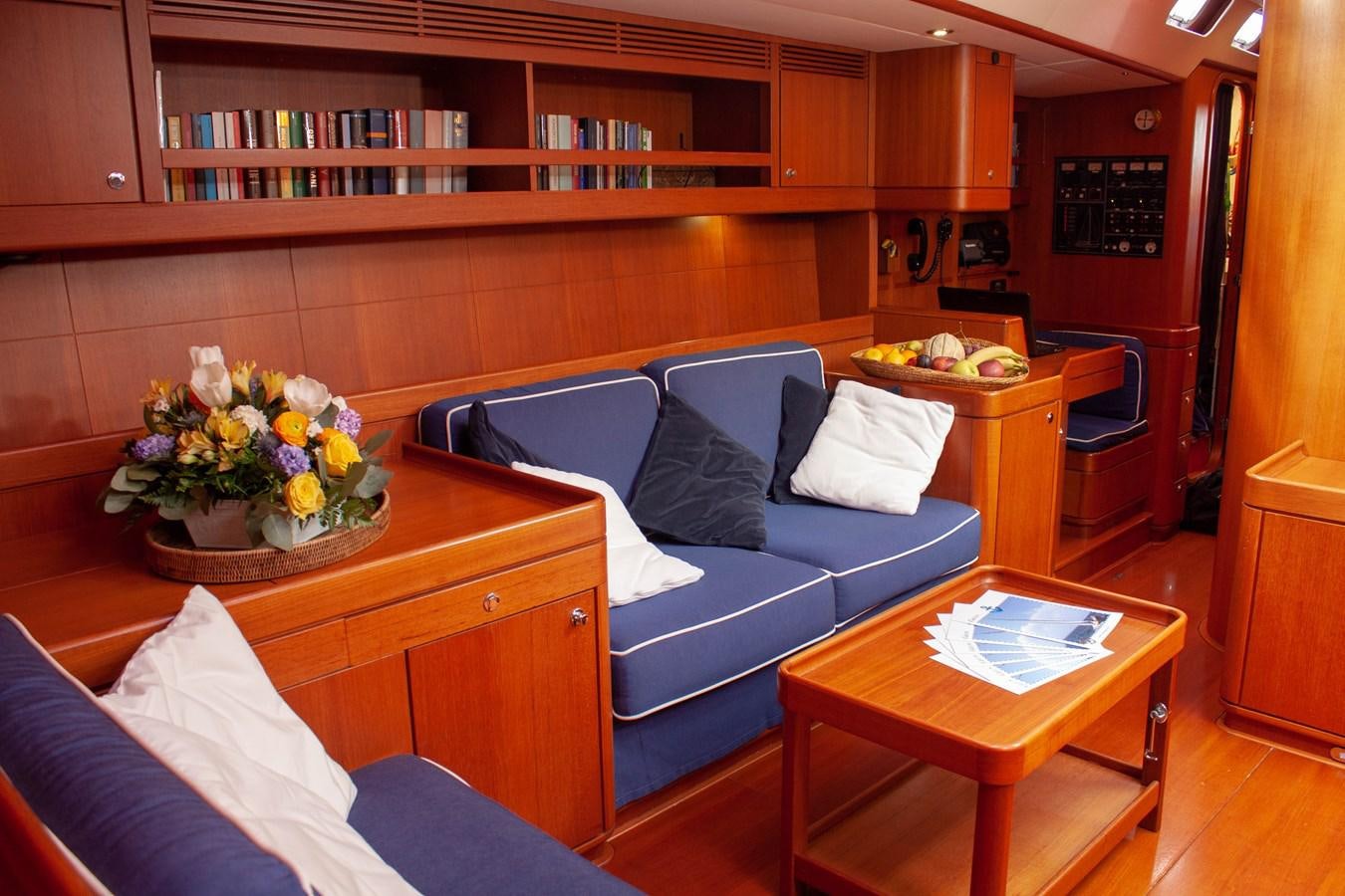 a living room with a couch and a table aboard NAUTA-PETERSON 75 Yacht for Sale