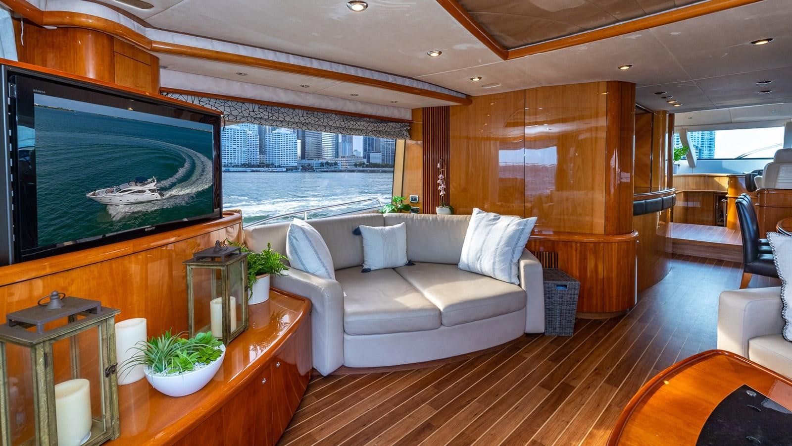 a living room with a large screen aboard ICONIC Yacht for Sale