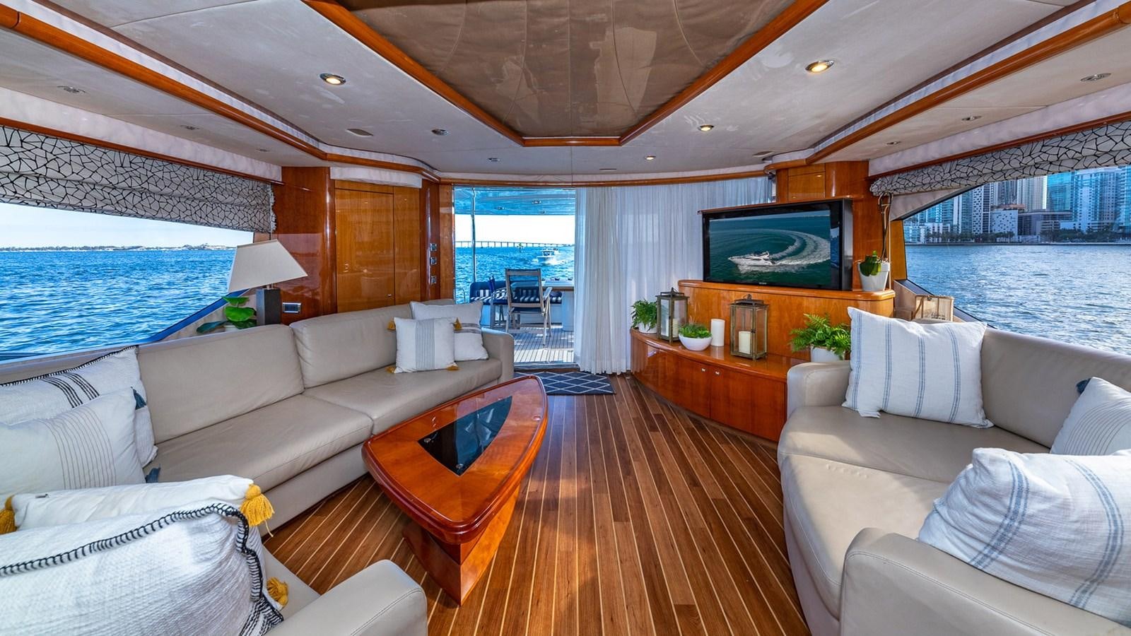 a living room with a large television aboard ICONIC Yacht for Sale