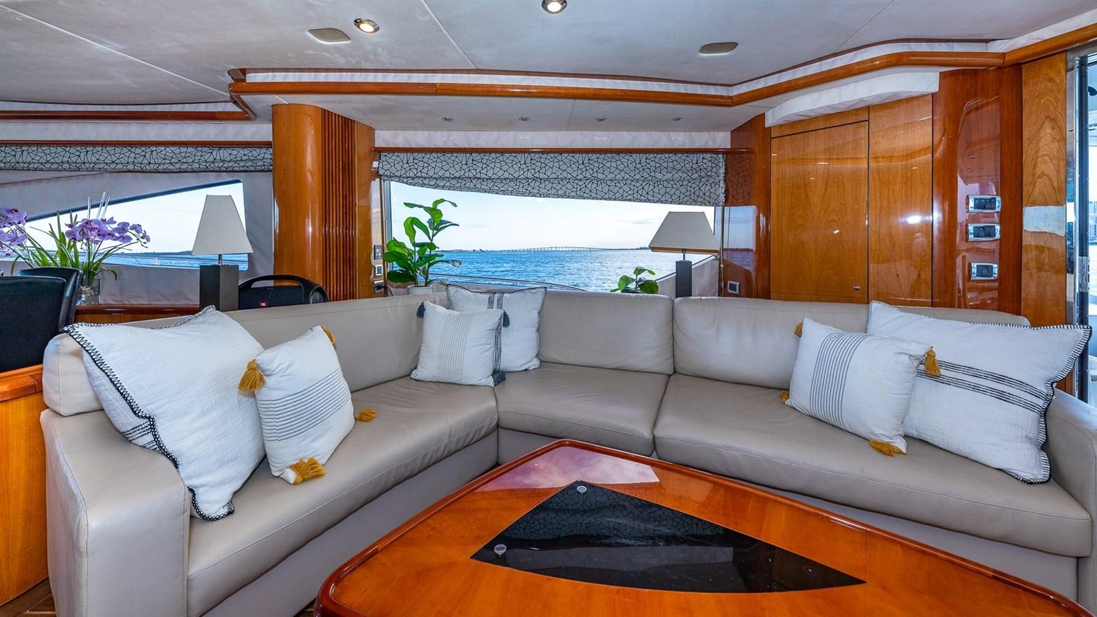 a living room with a couch and a large window aboard ICONIC Yacht for Sale