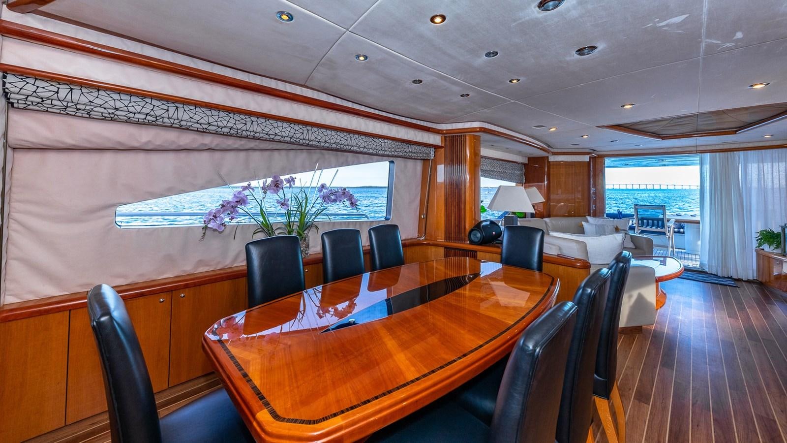 a room with a table and chairs aboard ICONIC Yacht for Sale