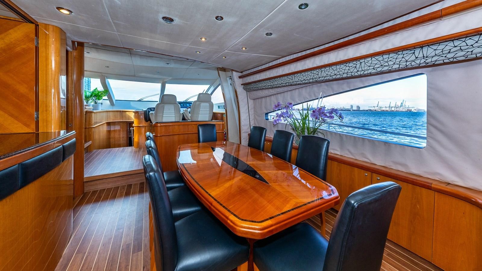 a table and chairs in a room aboard ICONIC Yacht for Sale