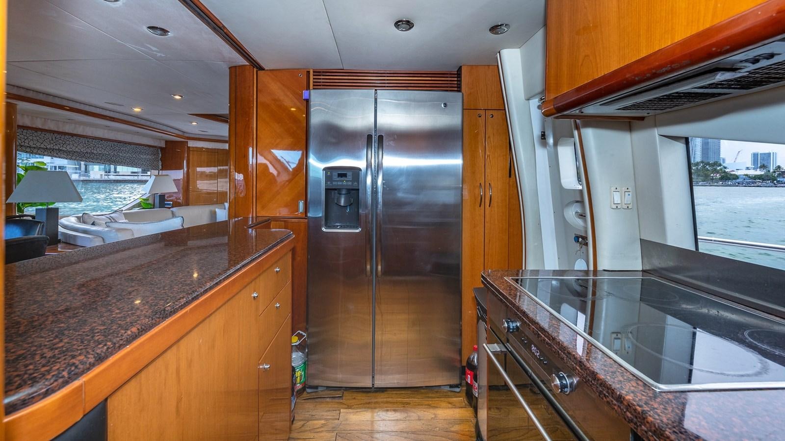 a kitchen with a stainless steel refrigerator aboard ICONIC Yacht for Sale