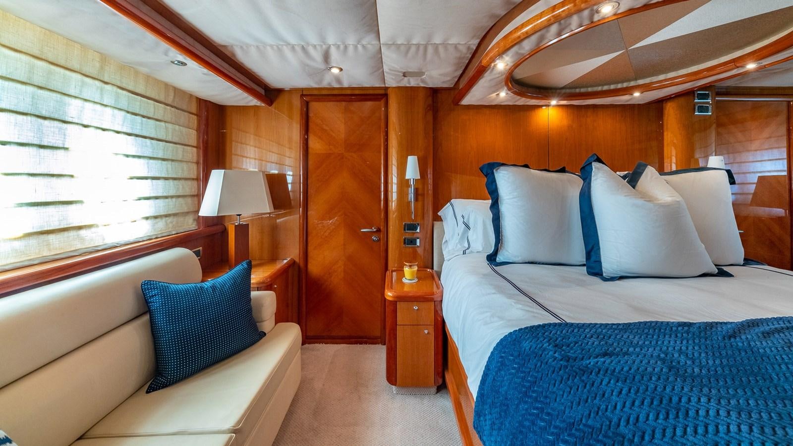 a room with a bed and a desk aboard ICONIC Yacht for Sale