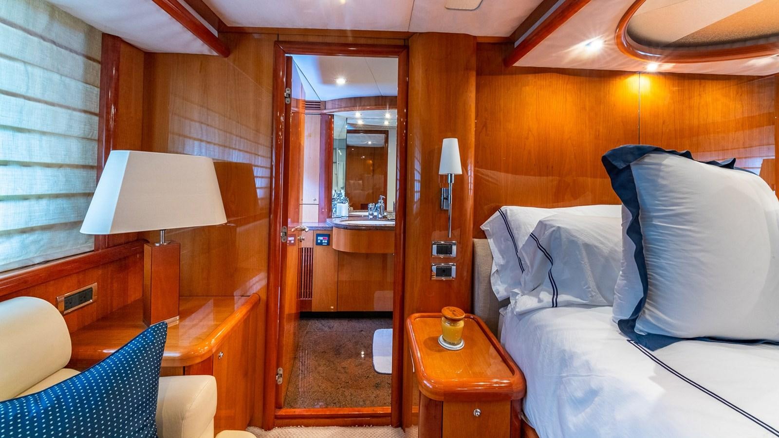 a room with a bed and a desk aboard ICONIC Yacht for Sale