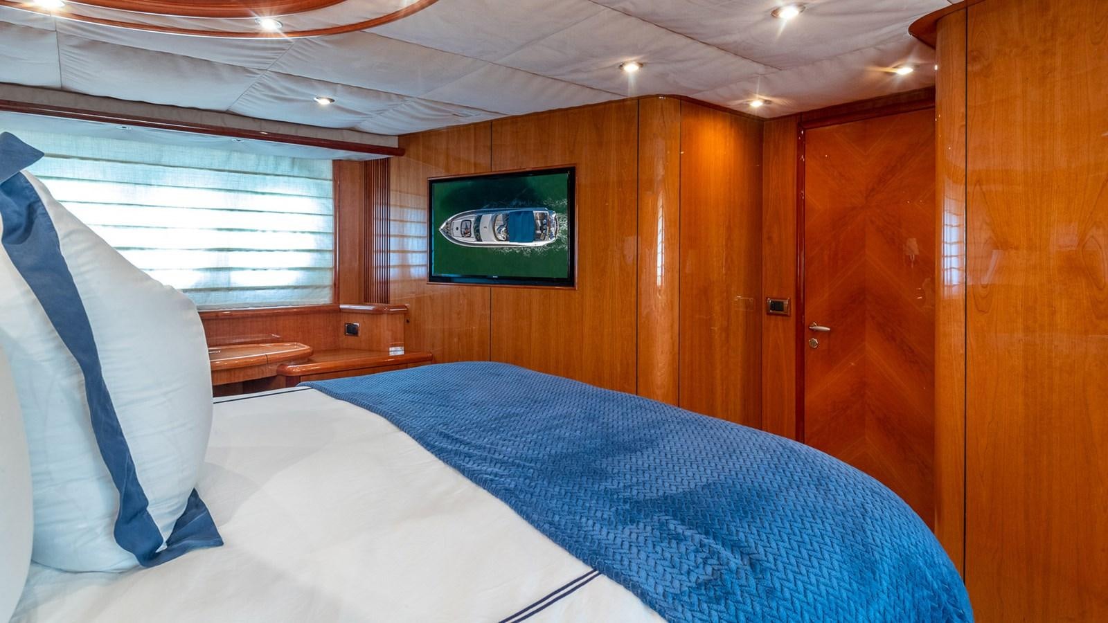 a bed with a blue sheet aboard ICONIC Yacht for Sale