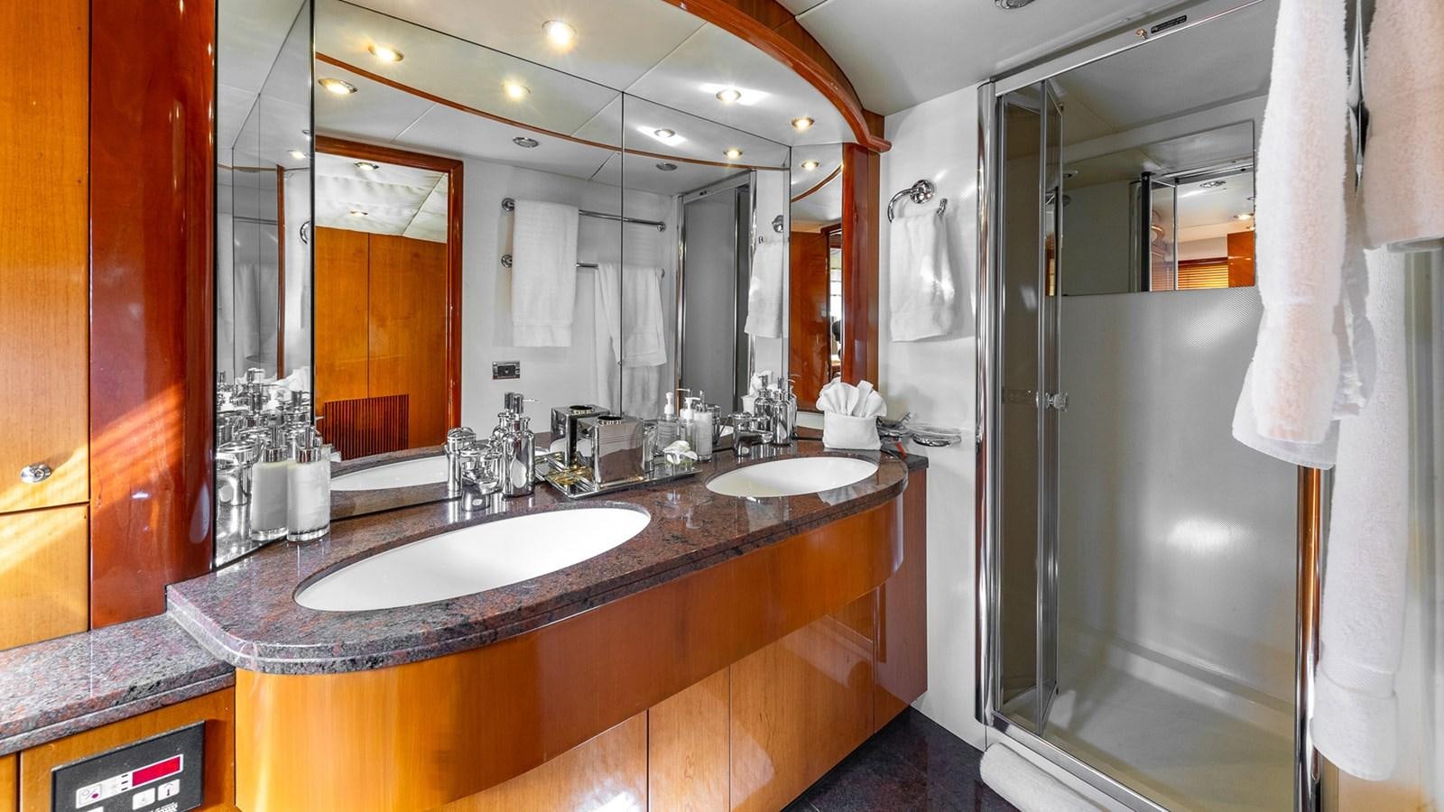 a bathroom with a countertop sink and mirrors aboard ICONIC Yacht for Sale