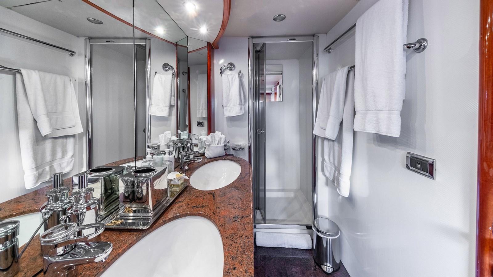 a bathroom with a countertop sink and a large mirror aboard ICONIC Yacht for Sale