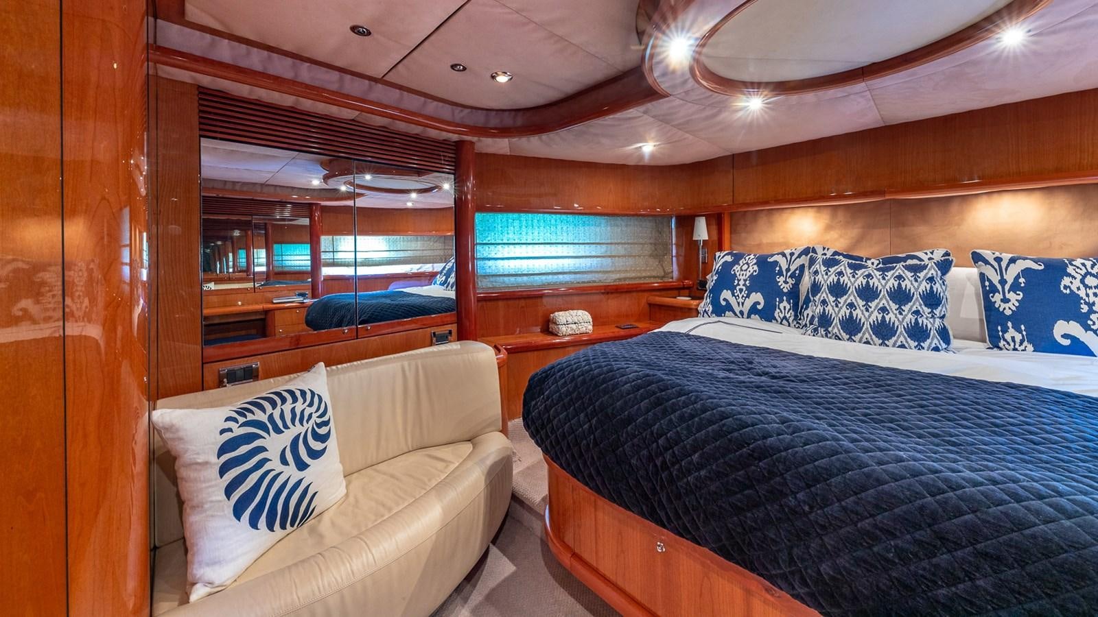a room with a bed and a couch aboard ICONIC Yacht for Sale