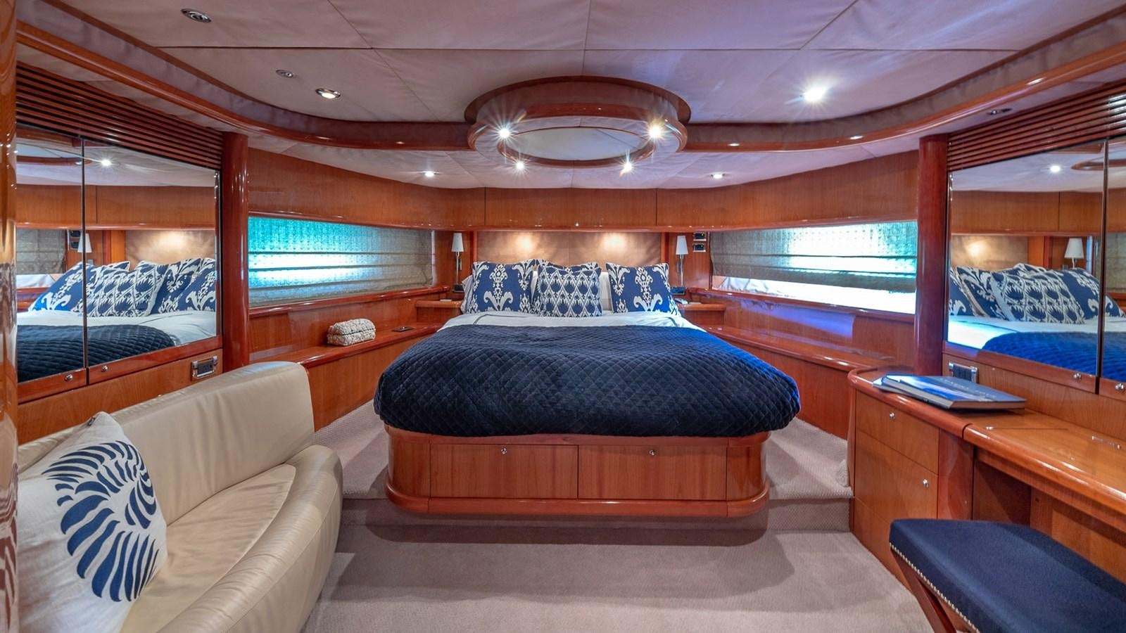 a room with a bed and a desk aboard ICONIC Yacht for Sale