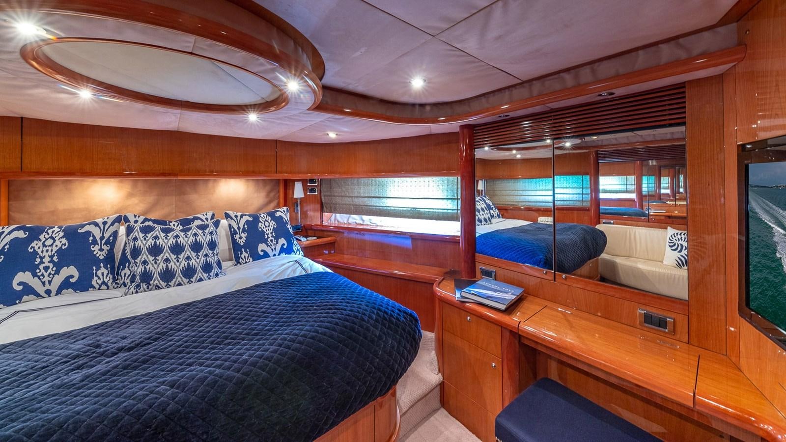a room with a bed and a desk aboard ICONIC Yacht for Sale