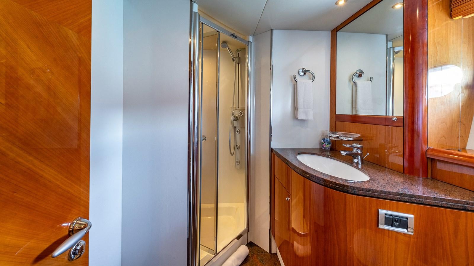 a bathroom with a sink and a mirror aboard ICONIC Yacht for Sale