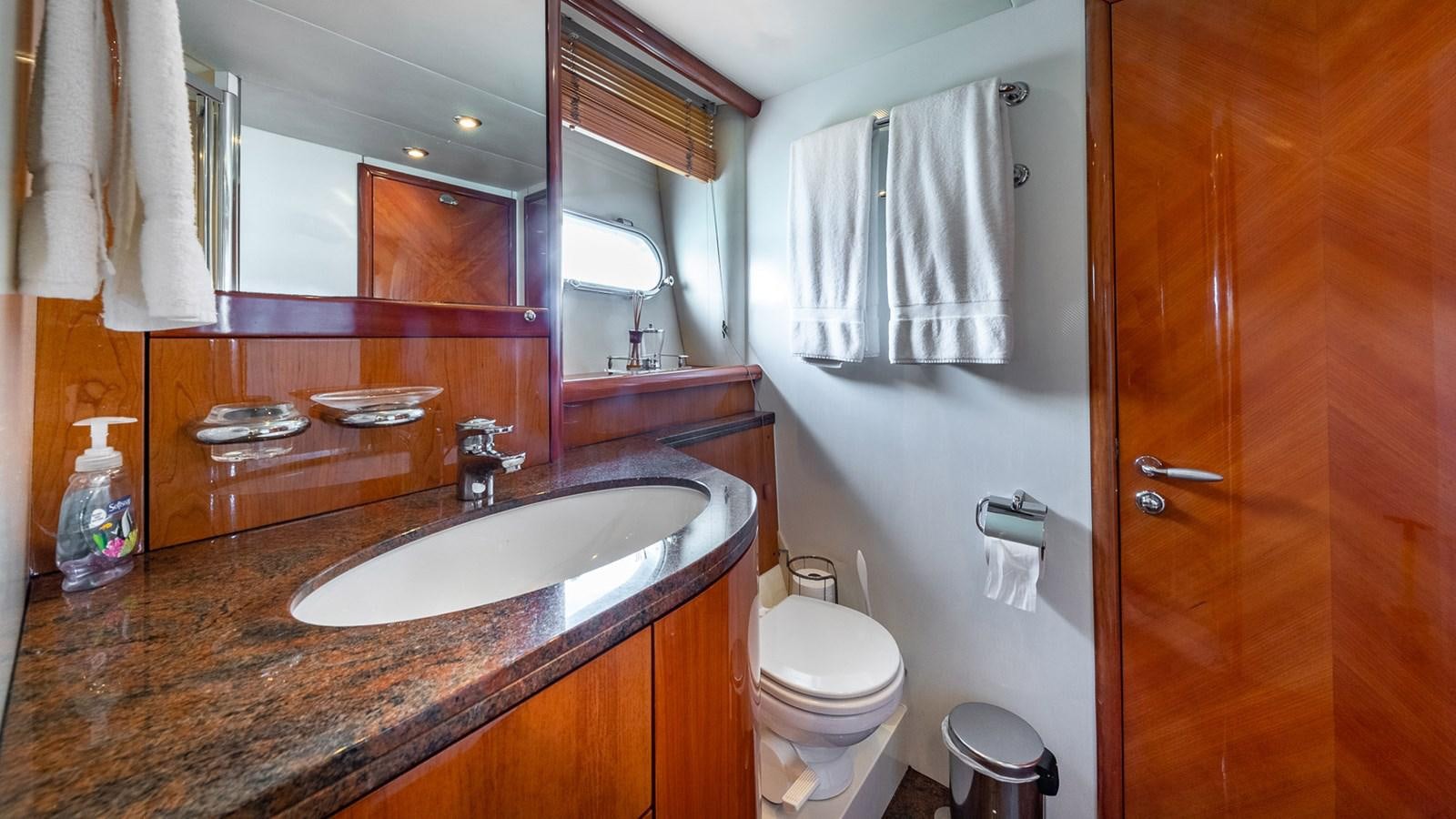 a bathroom with a sink toilet and a mirror aboard ICONIC Yacht for Sale