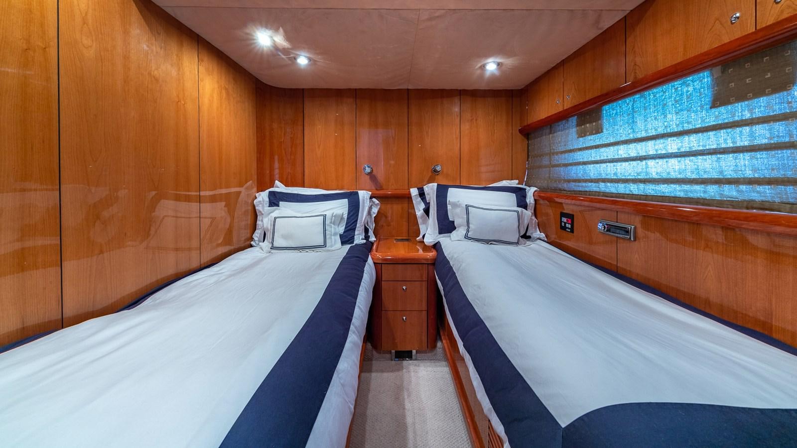 a room with wooden walls and a couple of beds aboard ICONIC Yacht for Sale