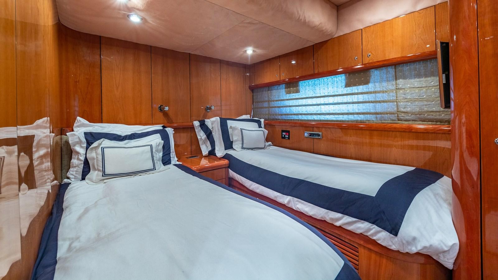 a room with two beds aboard ICONIC Yacht for Sale