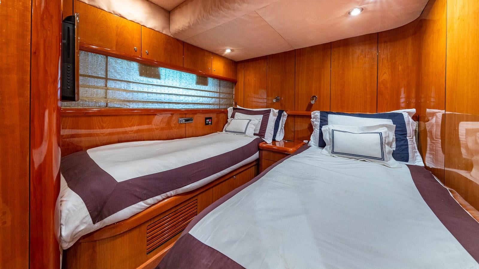 a room with two beds aboard ICONIC Yacht for Sale