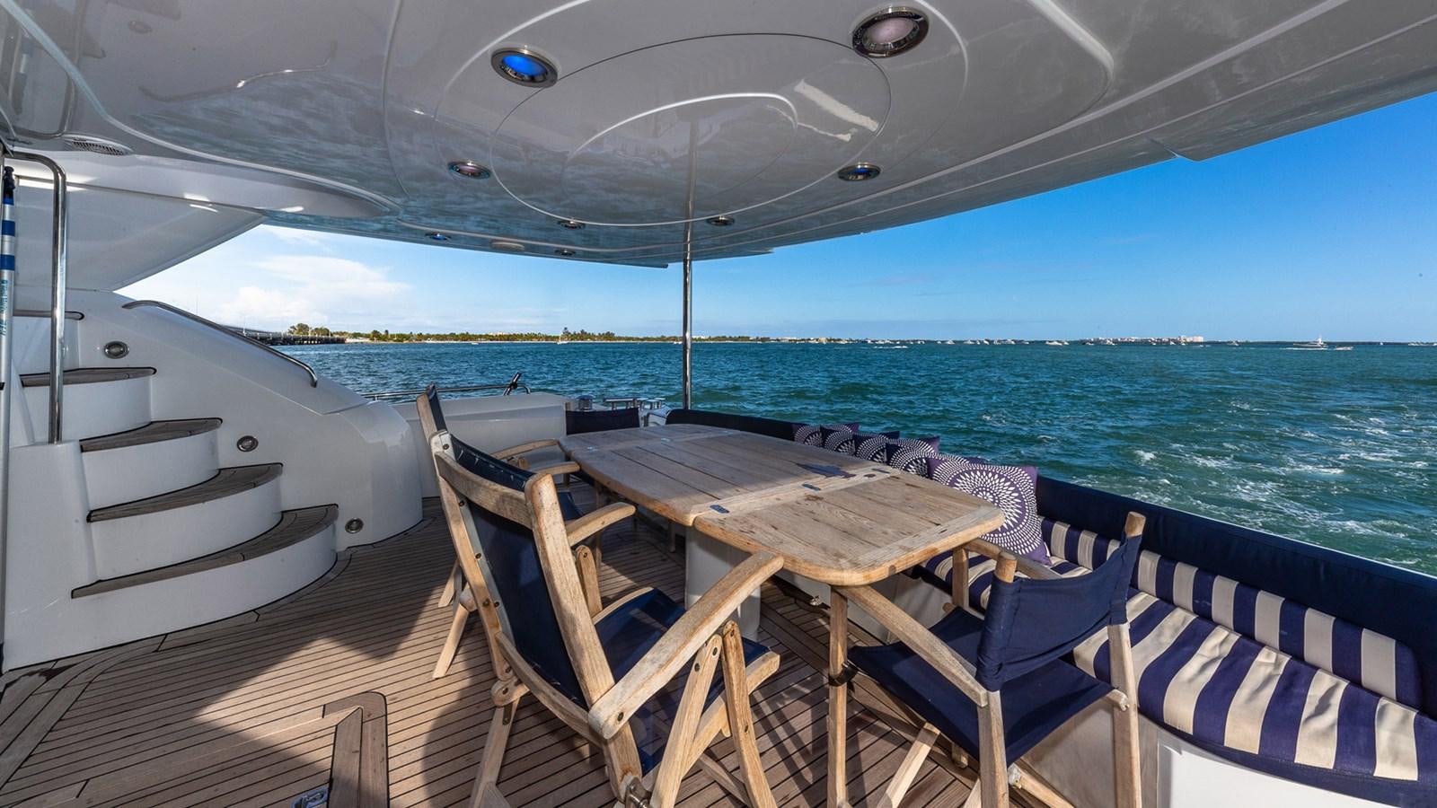 a table and chairs on a deck aboard ICONIC Yacht for Sale