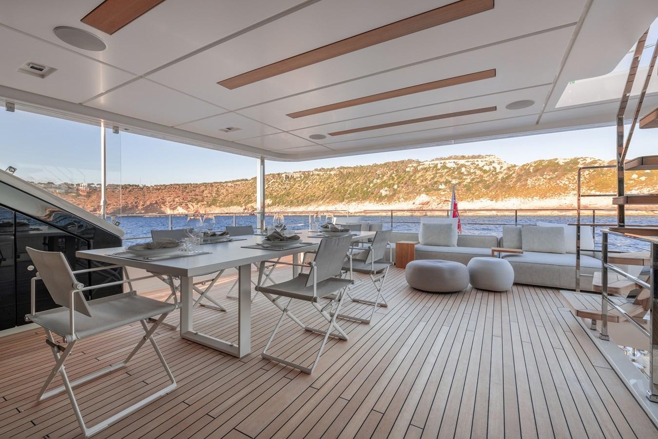 a deck with a view of the water and the land below aboard PALOMA Yacht for Sale