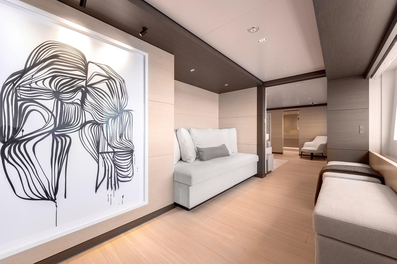 a room with a couch and a painting on the wall aboard PALOMA Yacht for Sale