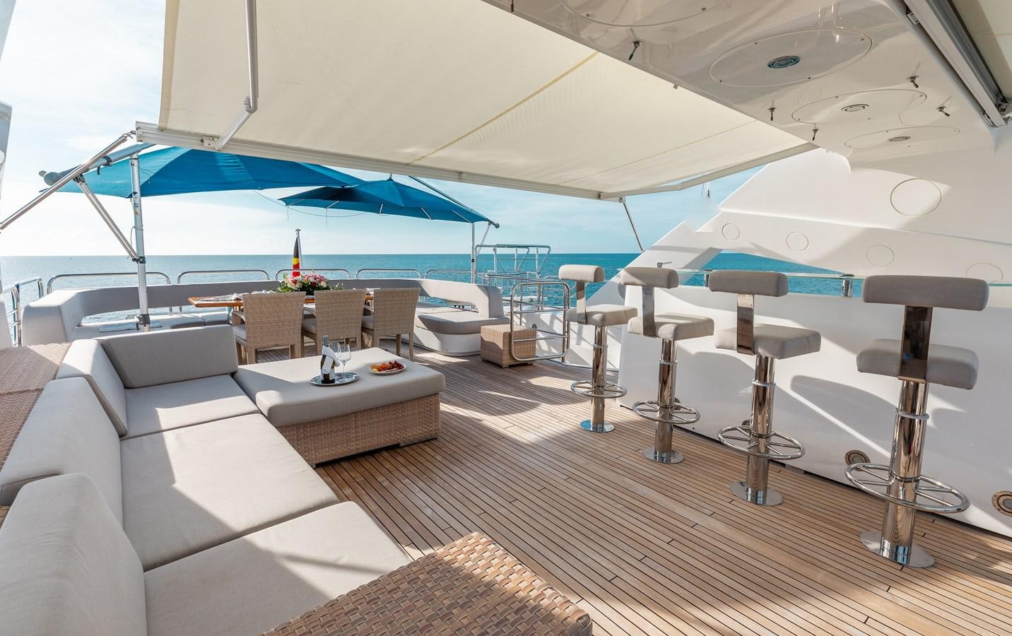 a room with a large lounge chair and a large umbrella over the pool aboard AQUARIUM Yacht for Sale