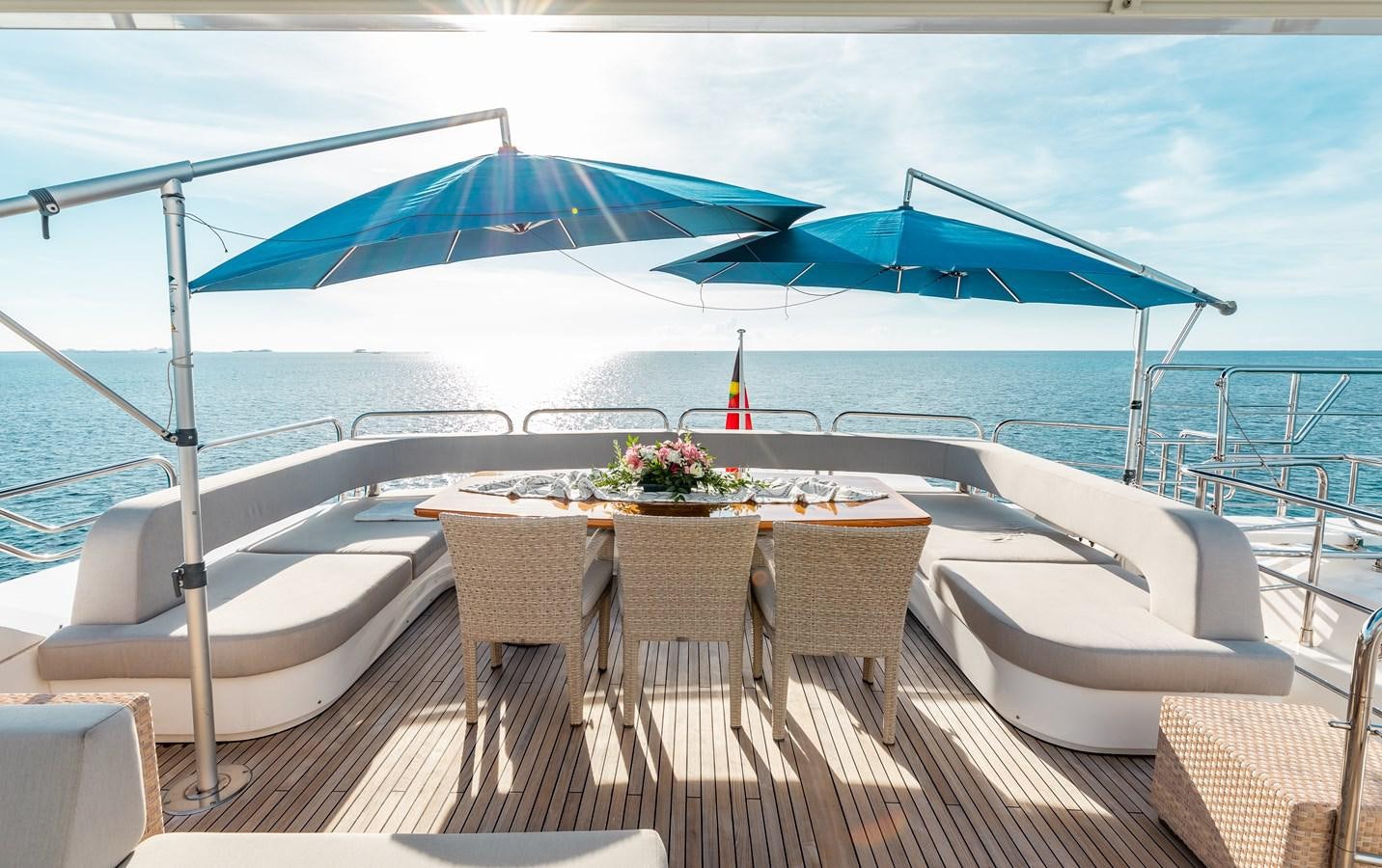 a table and chairs on a beach aboard AQUARIUM Yacht for Sale