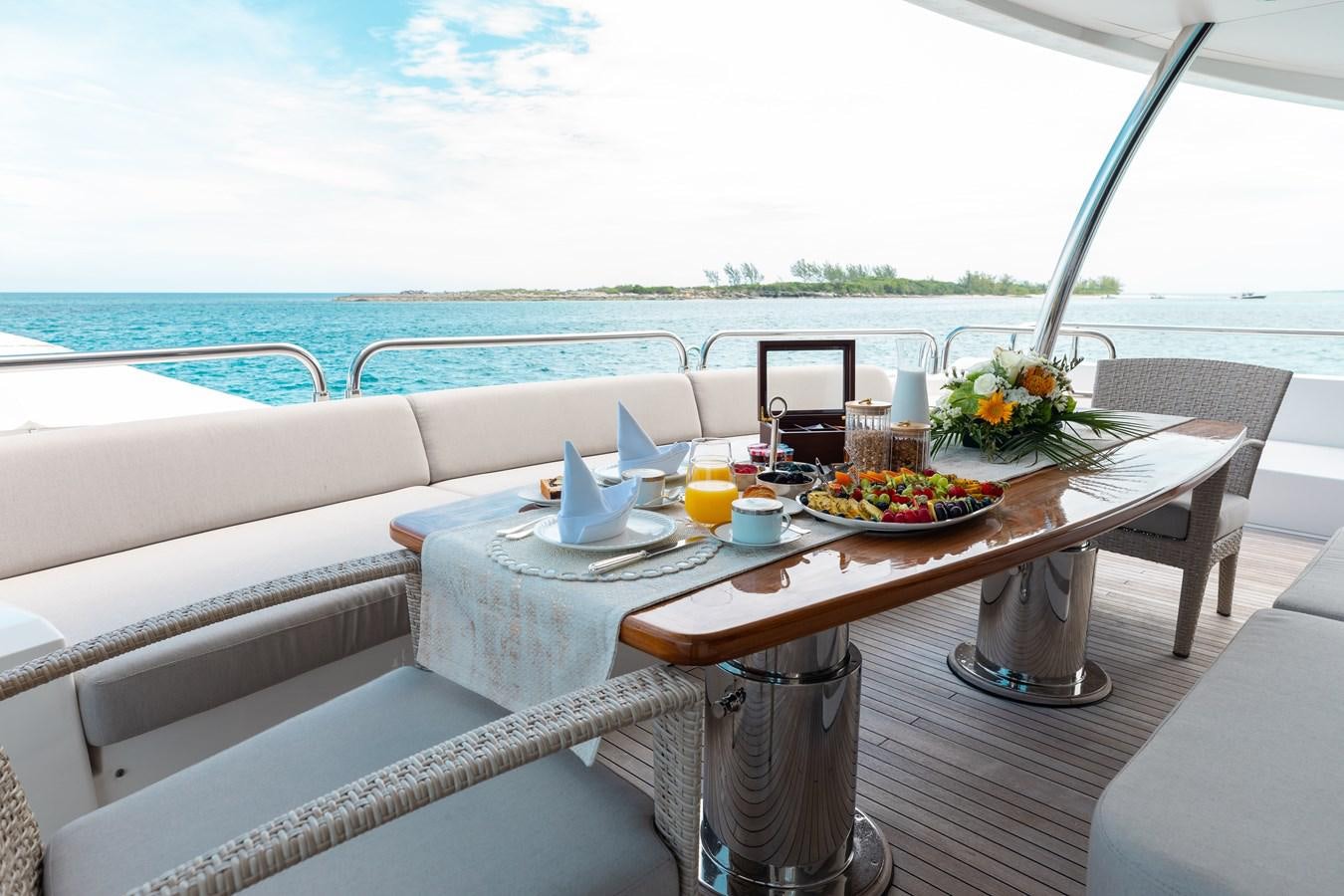 a table on a balcony aboard AQUARIUM Yacht for Sale