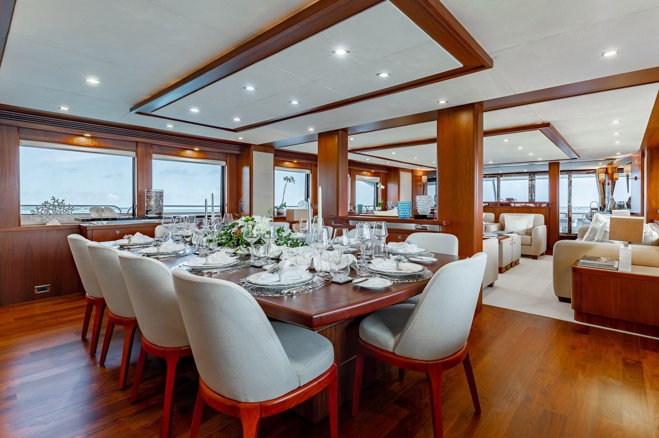 a large dining table in a room aboard AQUARIUM Yacht for Sale