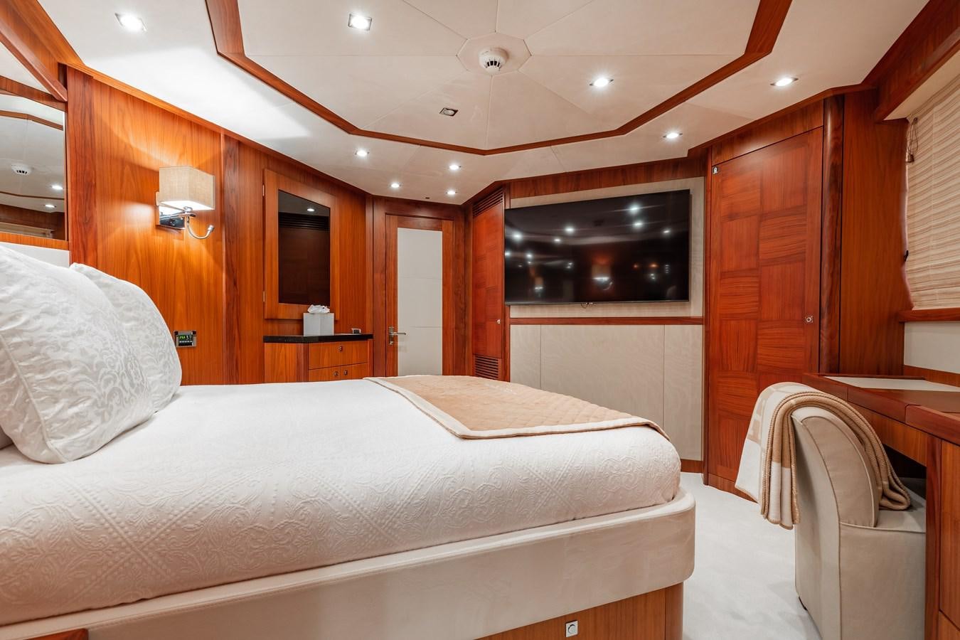 a room with a bed and a television aboard AQUARIUM Yacht for Sale