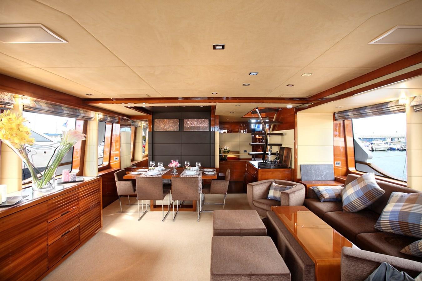 a room with couches and tables aboard XOXO Yacht for Sale
