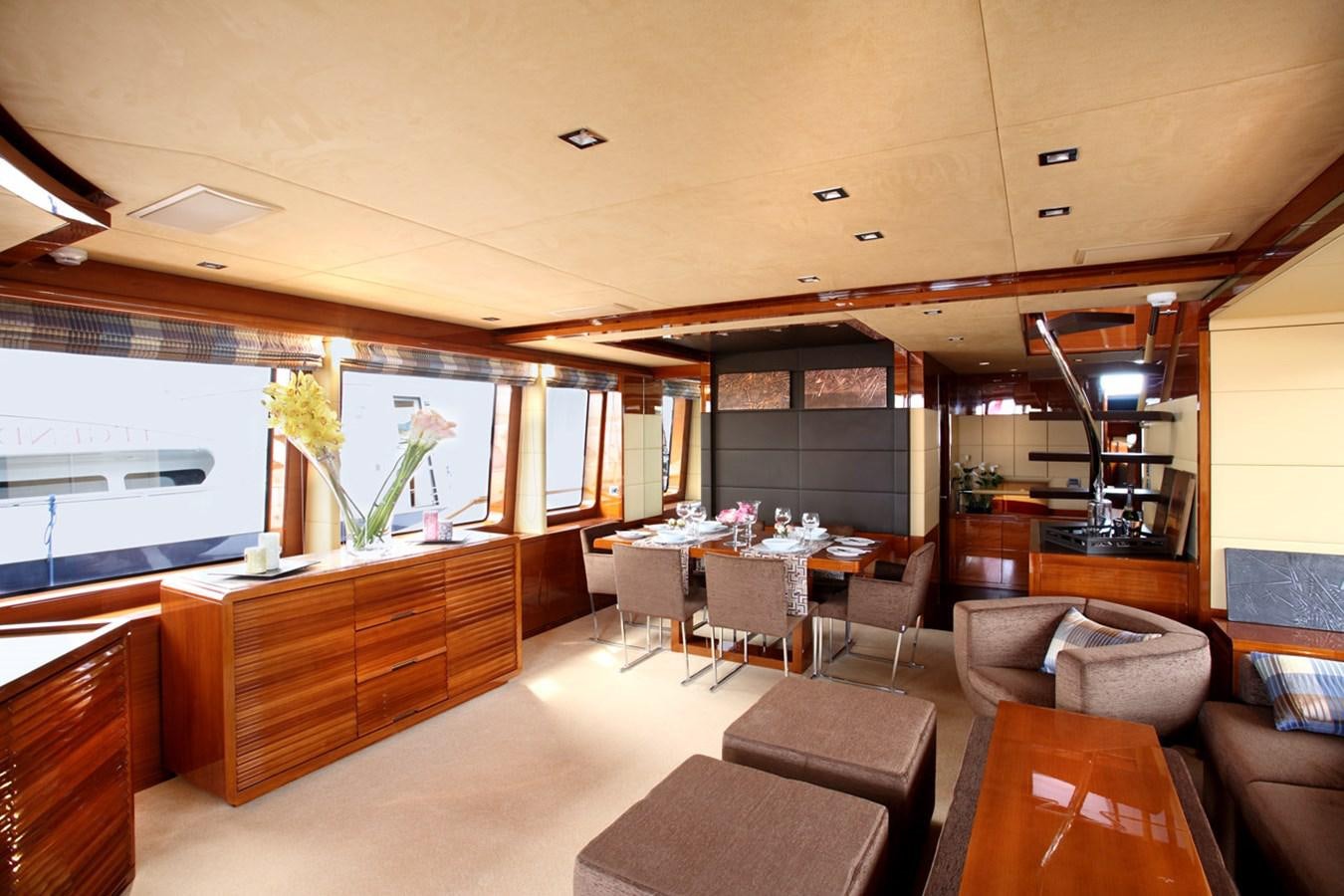 a large room with a table and chairs aboard XOXO Yacht for Sale