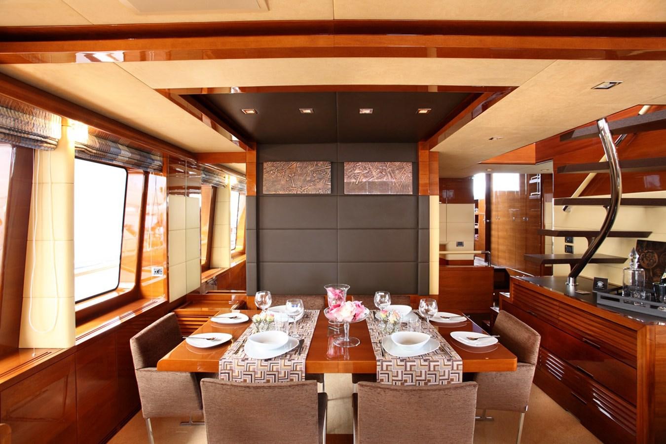 a dining room with a table aboard XOXO Yacht for Sale