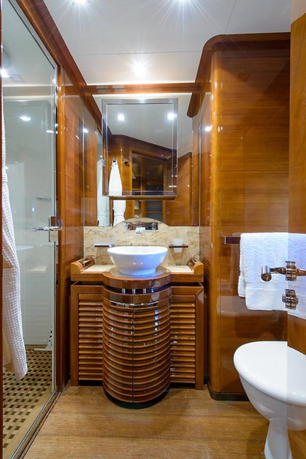 a bathroom with a sink and a mirror aboard XOXO Yacht for Sale
