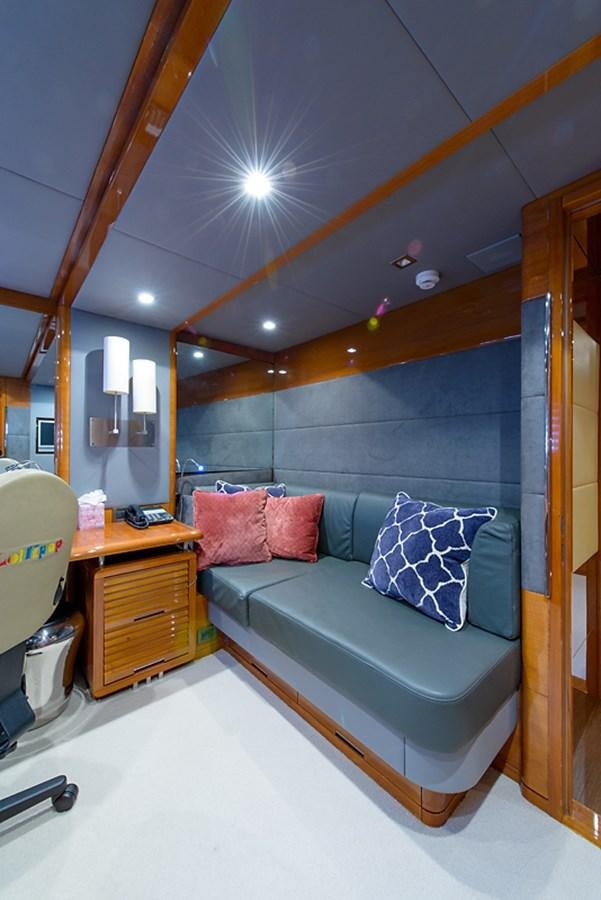 a bed with a blue pillow aboard XOXO Yacht for Sale