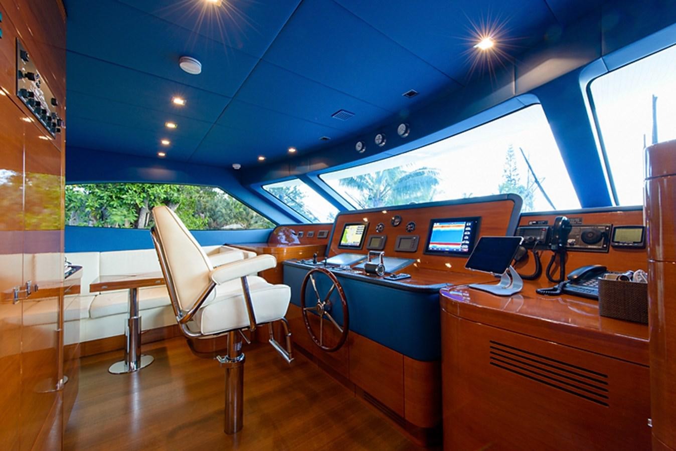 a room with a desk and chairs aboard XOXO Yacht for Sale