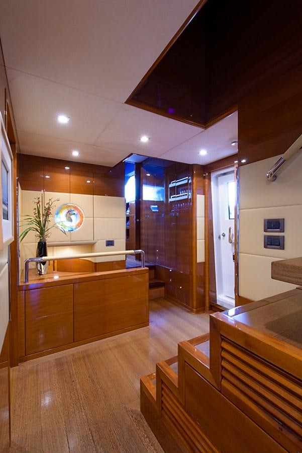 a kitchen with wooden cabinets aboard XOXO Yacht for Sale