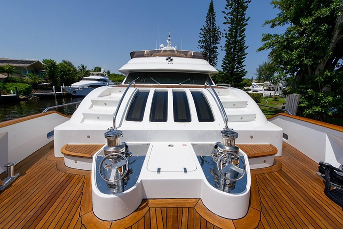 a white yacht on a dock aboard XOXO Yacht for Sale